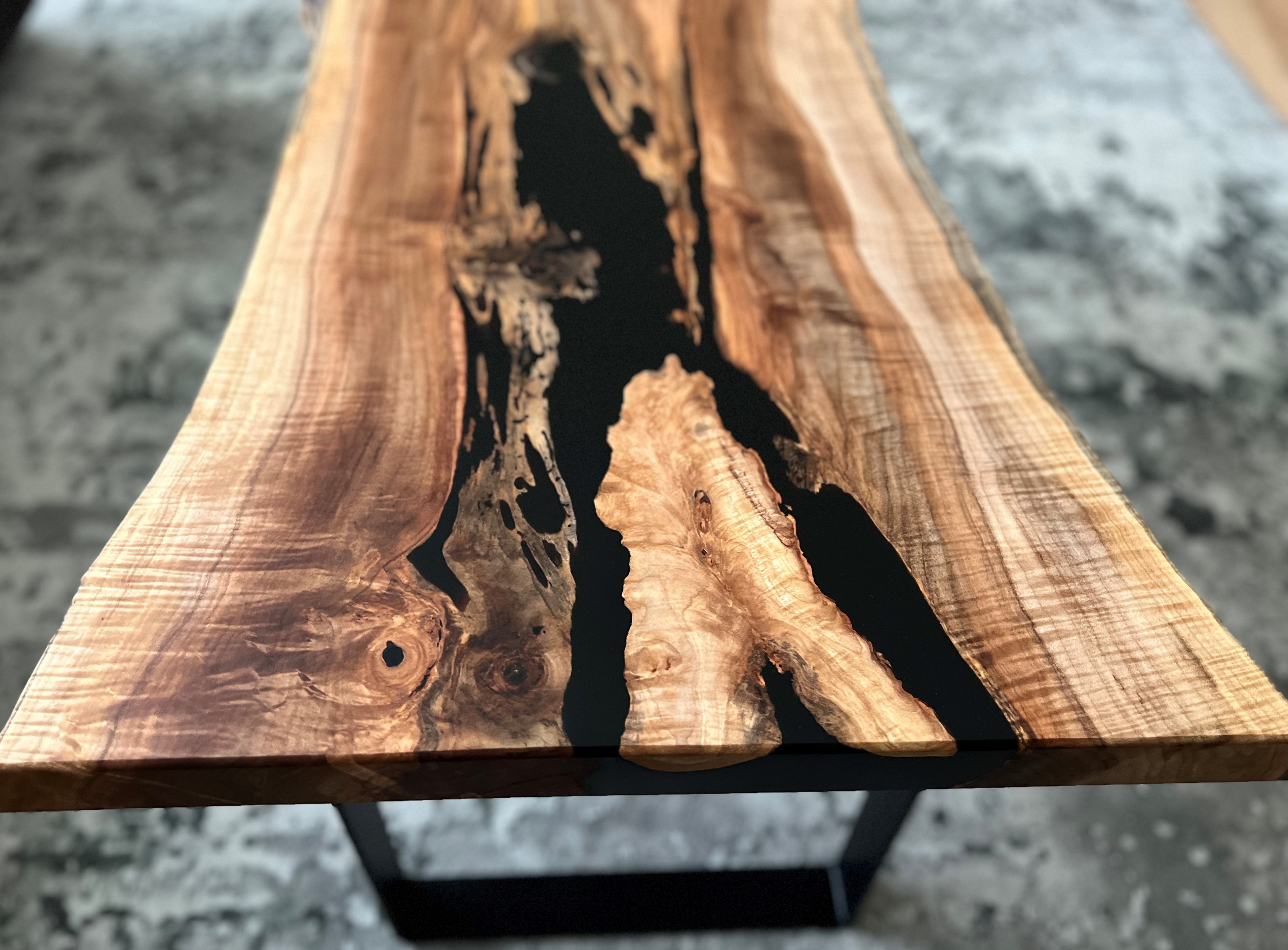 image of a live edge coffee table with black epoxy and a strong burl 